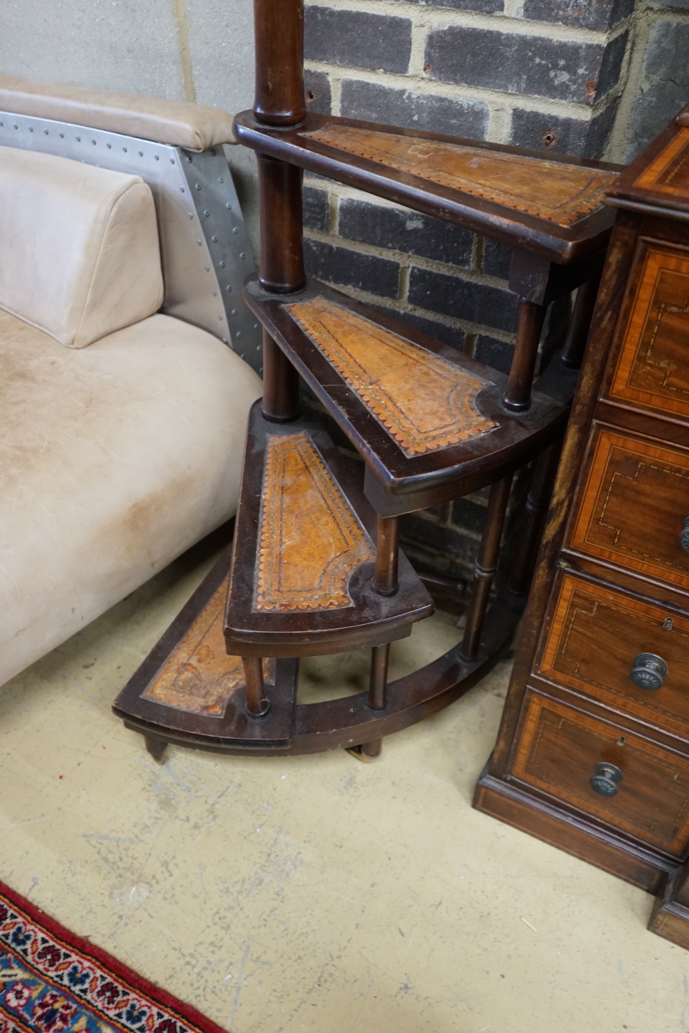 A set of reproduction Victorian style mahogany four tread library steps on brass castors, height 170cm
